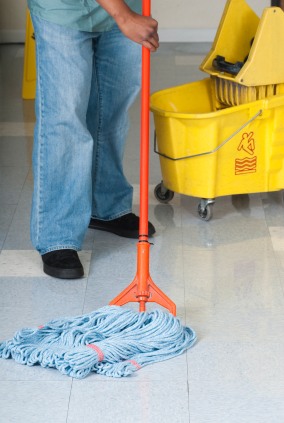 The Fifth Labor Miami LLC janitor in Wilton Manors, FL mopping floor.